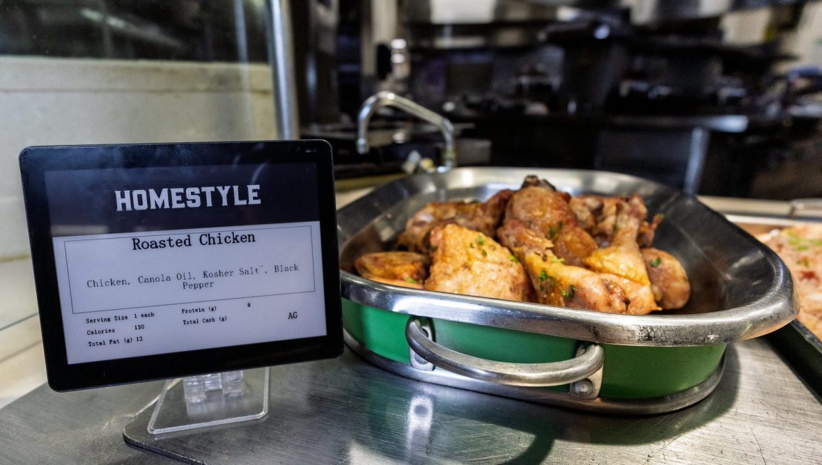 Closeup of a nutrition info card next to pan of roasted chicken.