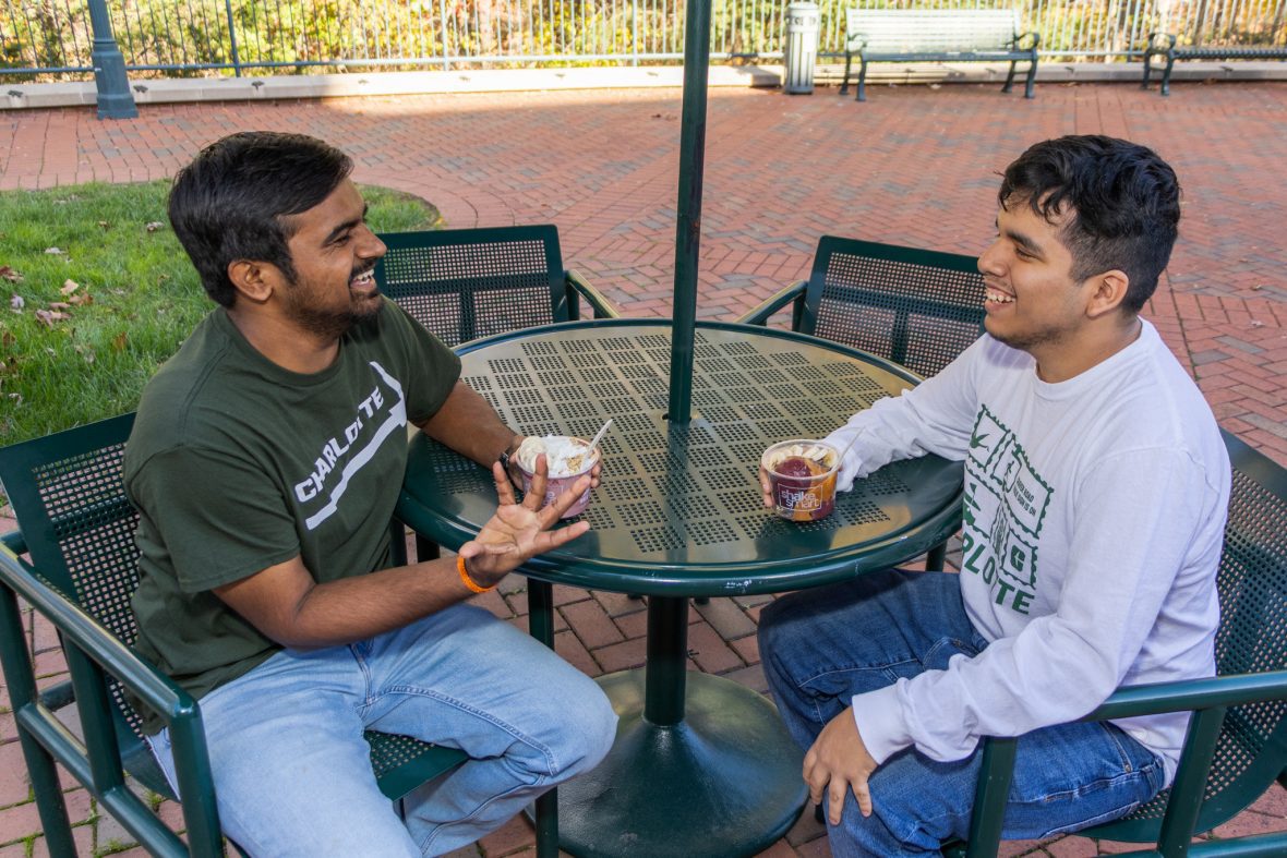 Students sitting with frozen yogurt at outside table