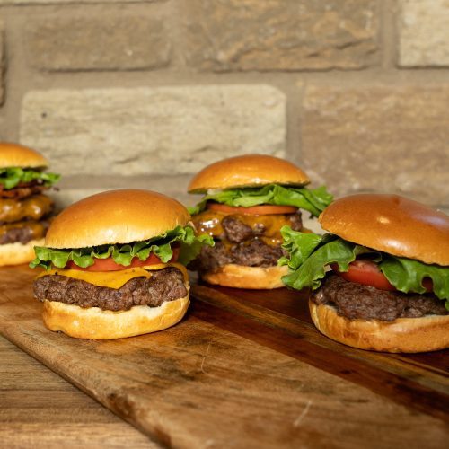 burgers on table with different toppings