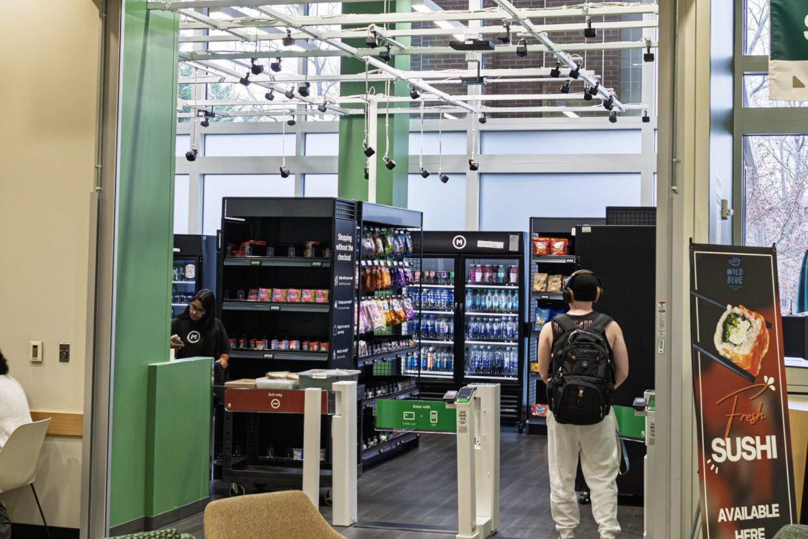 Picture showing the inside of amazon just walk out market and its sign above the doorway
