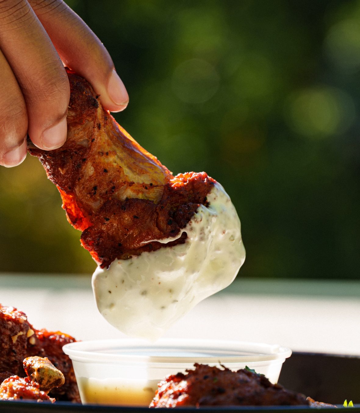 student dips a hot wing into ranch dip